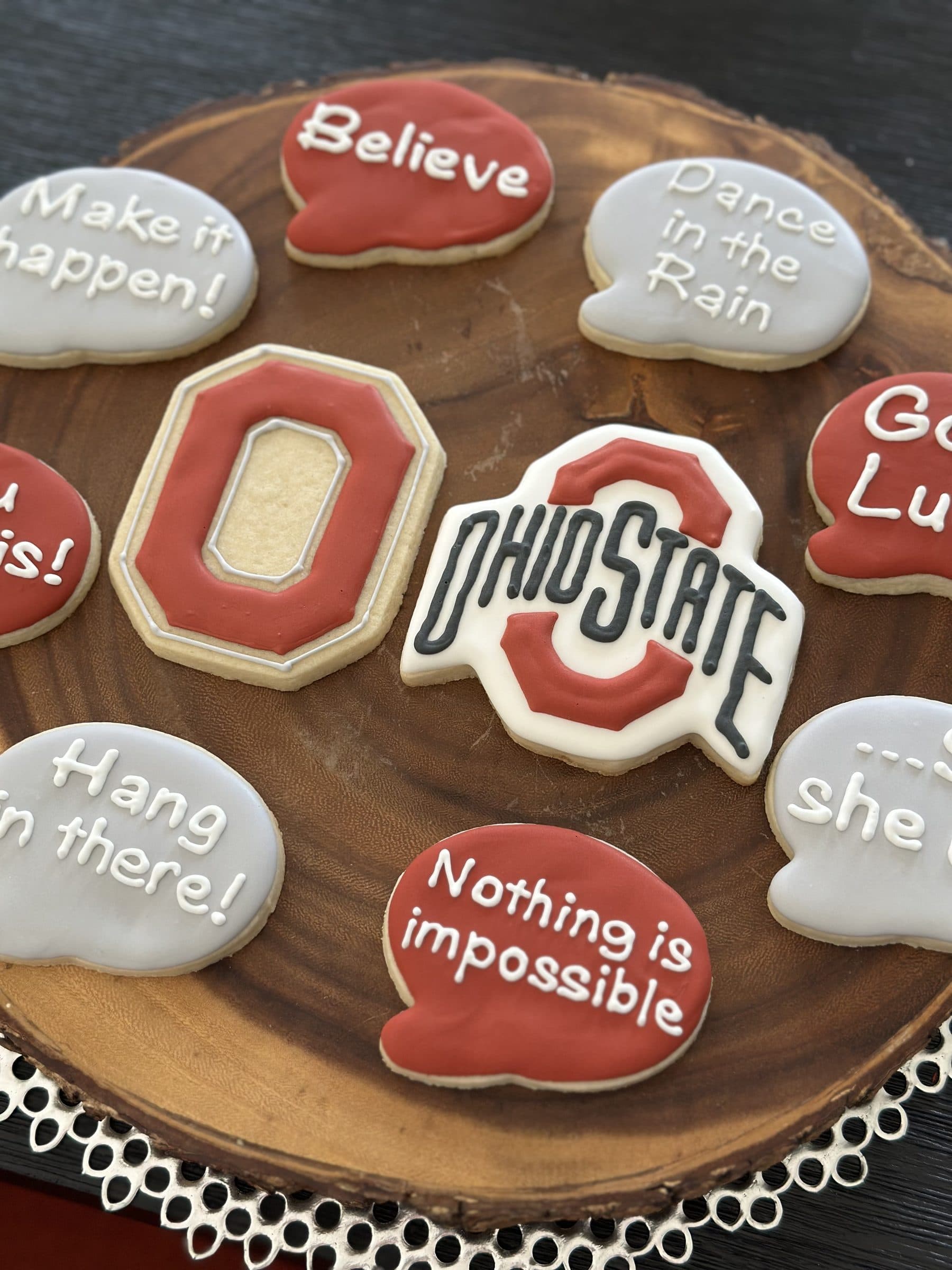 Ohio State Buckeyes cookies with encouraging messages on a wood board